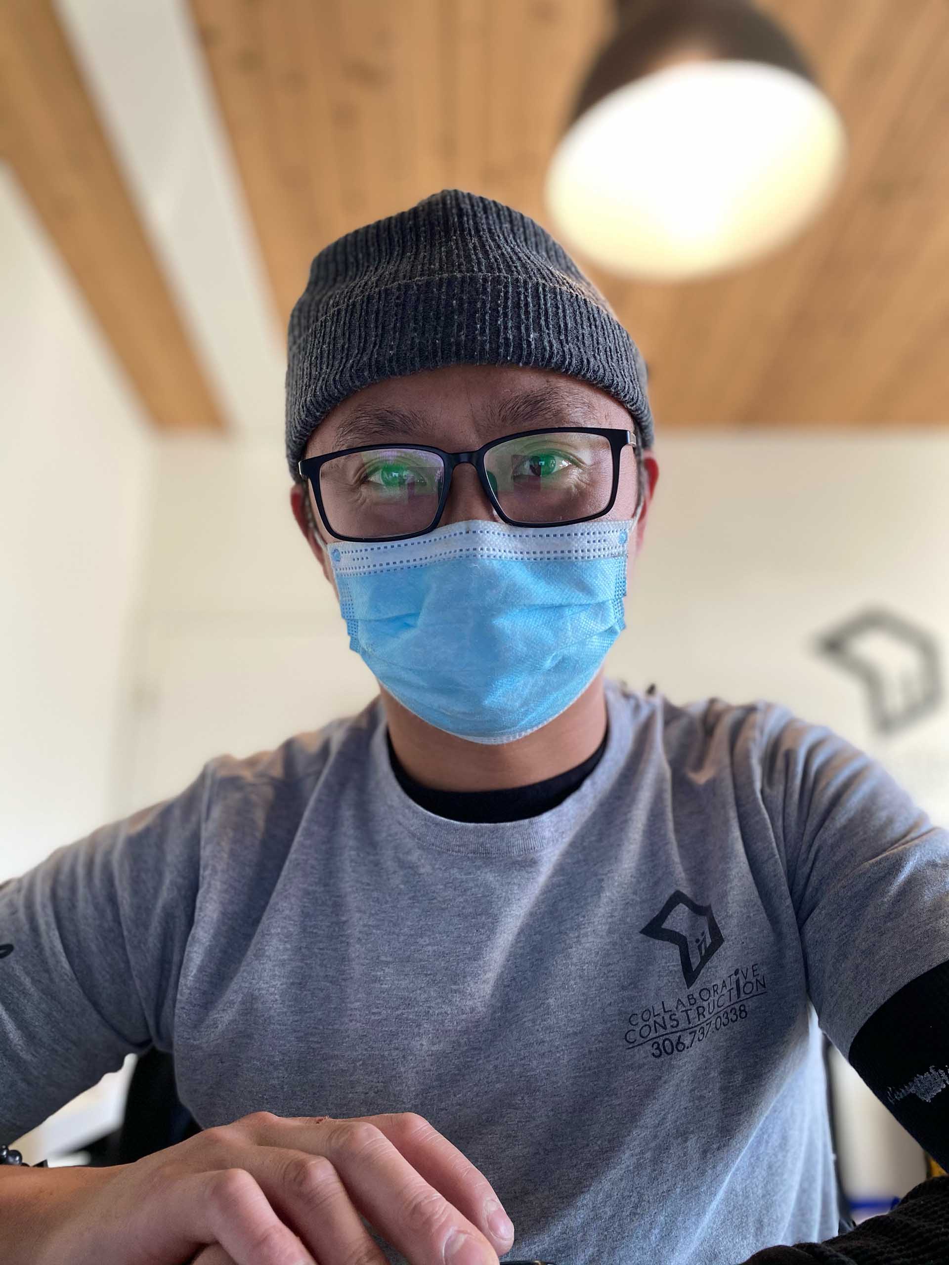 collaborative construction owner follows covid-19 guidelines by wearing mask