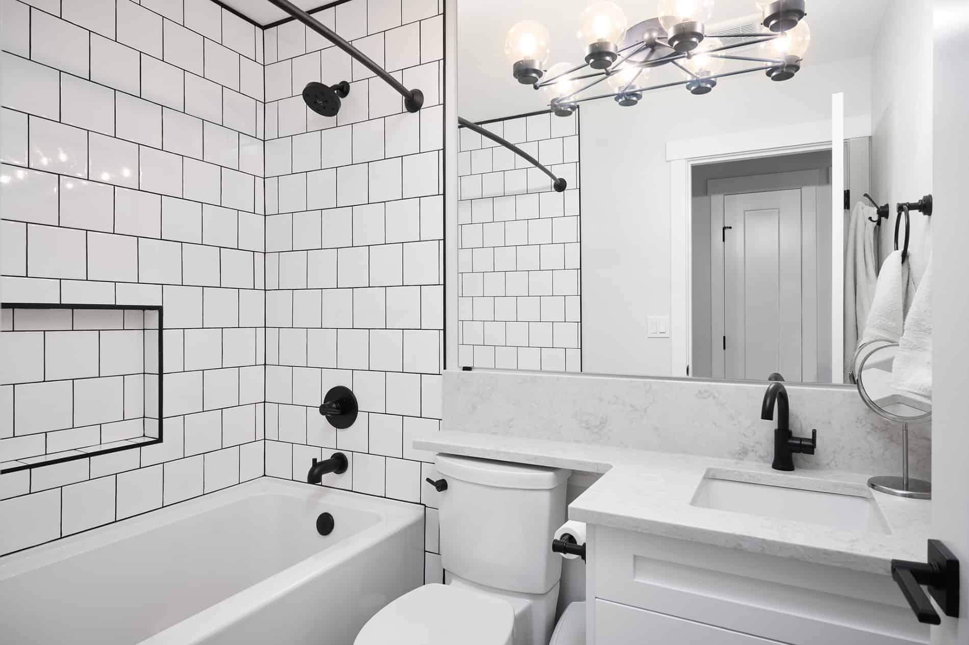 saskatchewan bathroom reno white subway tiles black grout and hardware