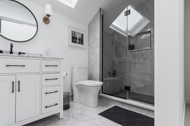 beautiful regina bathroom renovation with white walls and subtle grey marble tiles