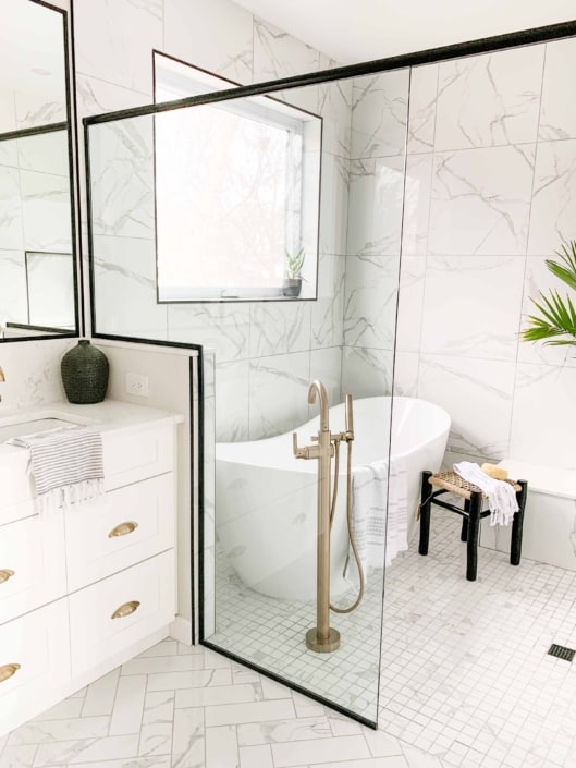 airy master bathroom with in shower freestanding bathtub and custom glass surround