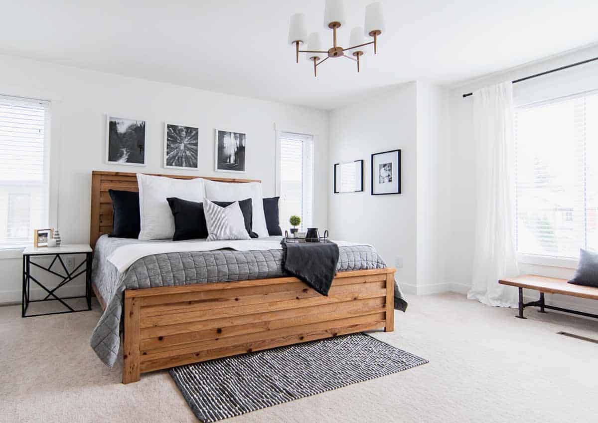 beige carpet in bedroom with wooden bedframe