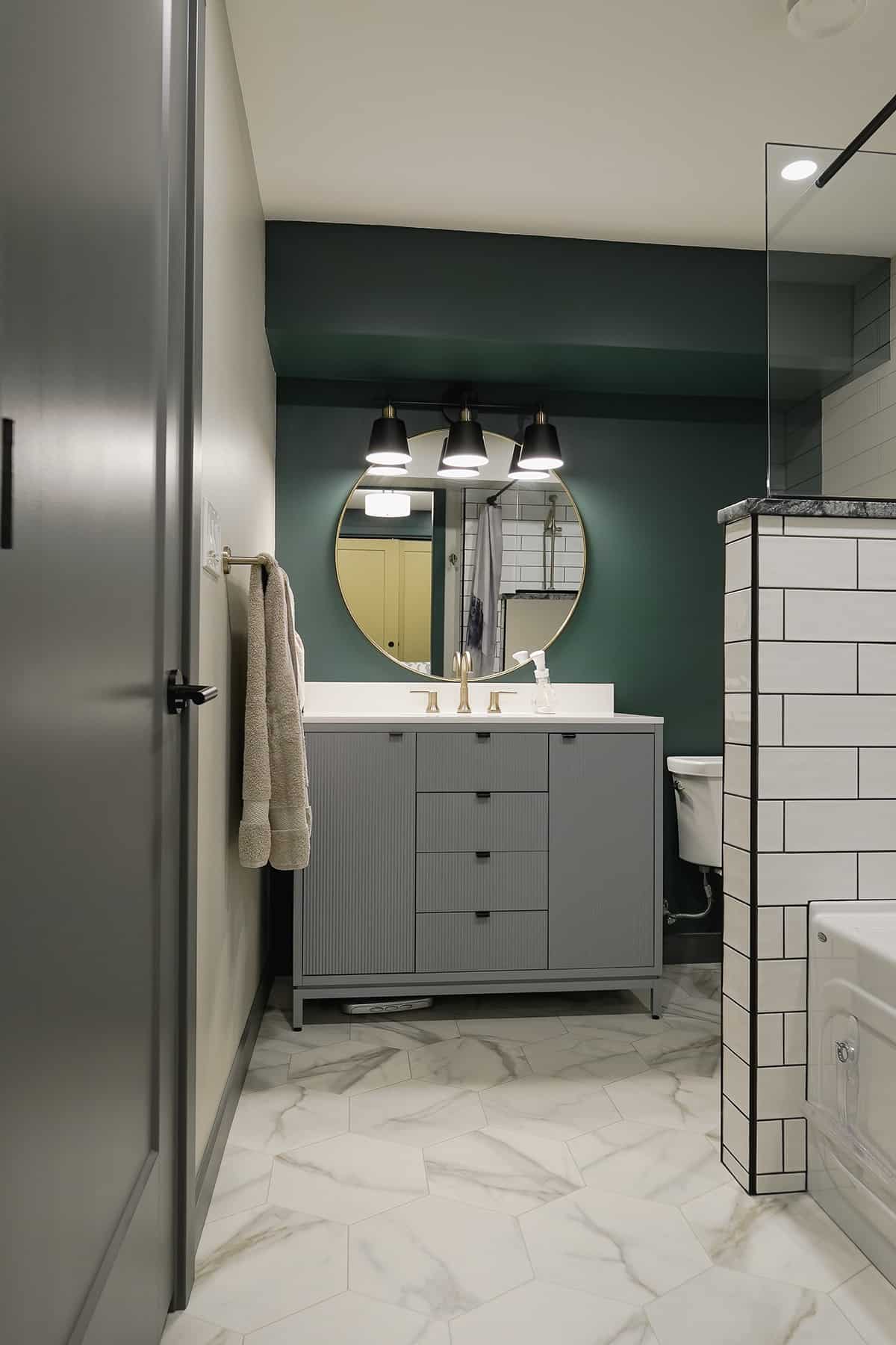 linoleum in bathroom with grey vanity and rich green walls