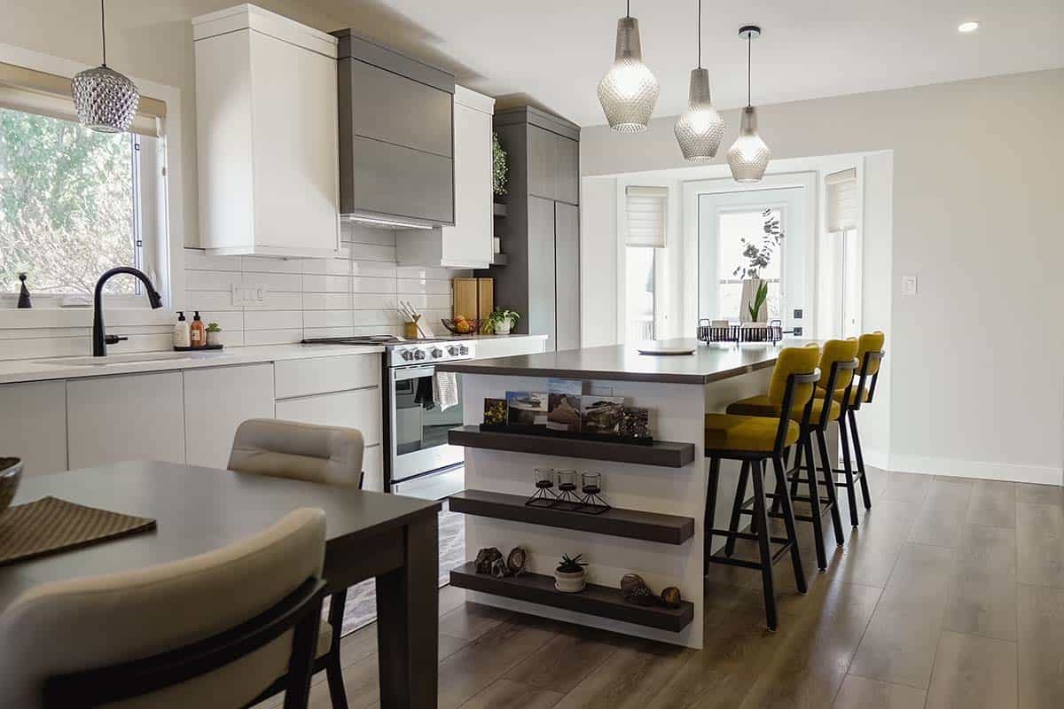 dark luxury vinyl plank flooring in kitchen with white subway tile and grey and white cabinets